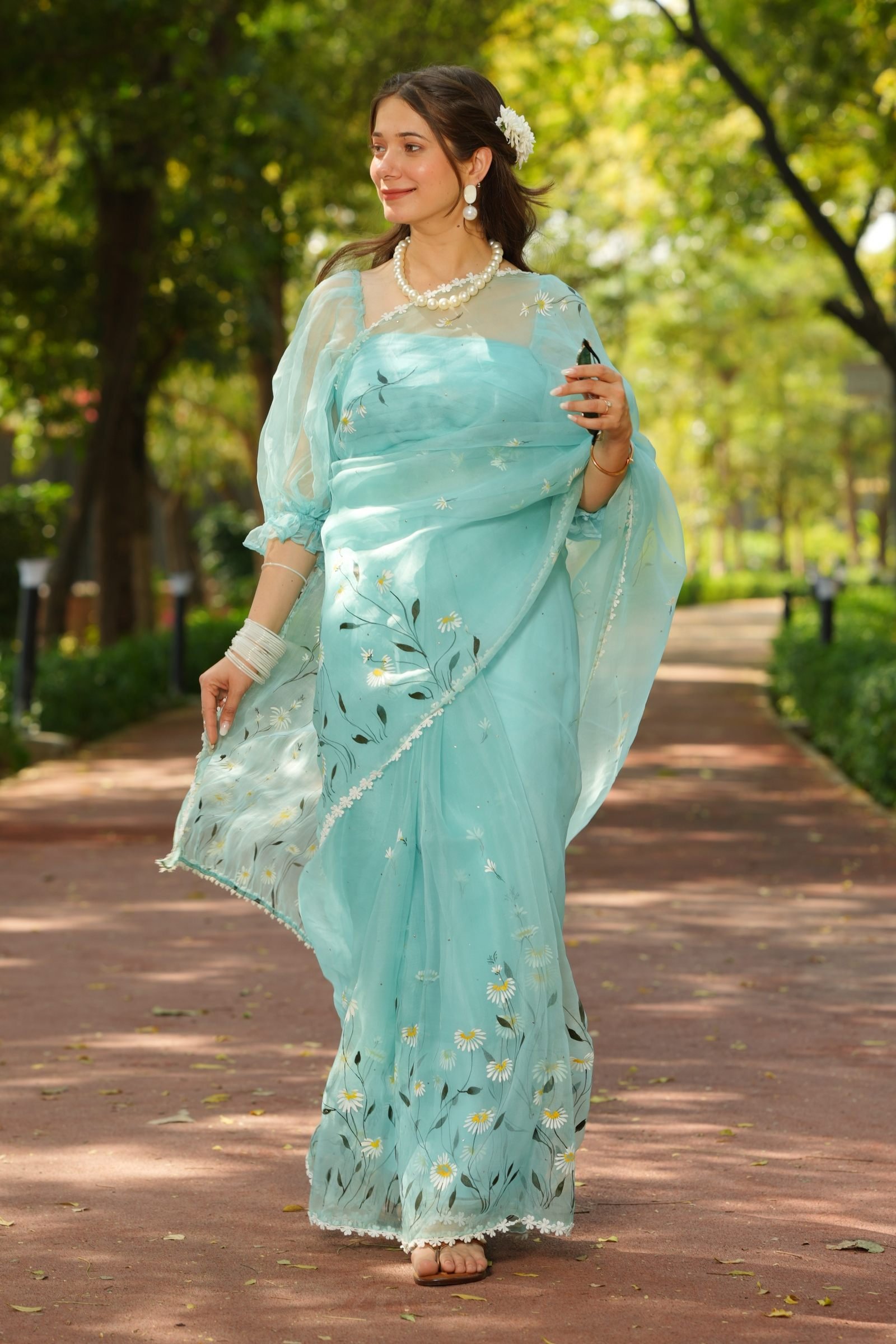 Azure Daisy Handpainted Organza Saree front view. Luxury pure silk drape with daisy motifs.