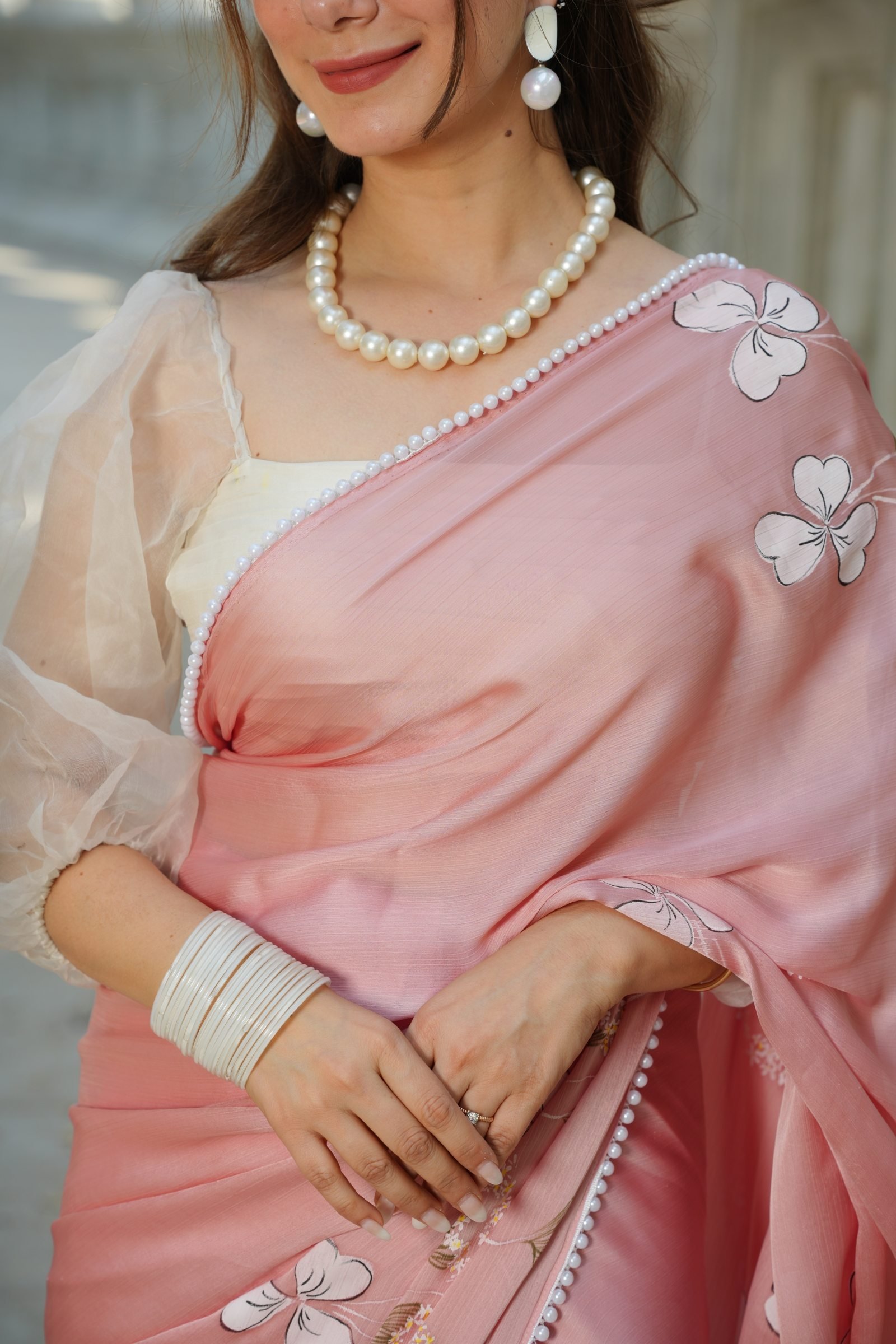 Close view of the pearl-beaded border and the soft sheen of the Blush Blossom Pure Silk Saree.