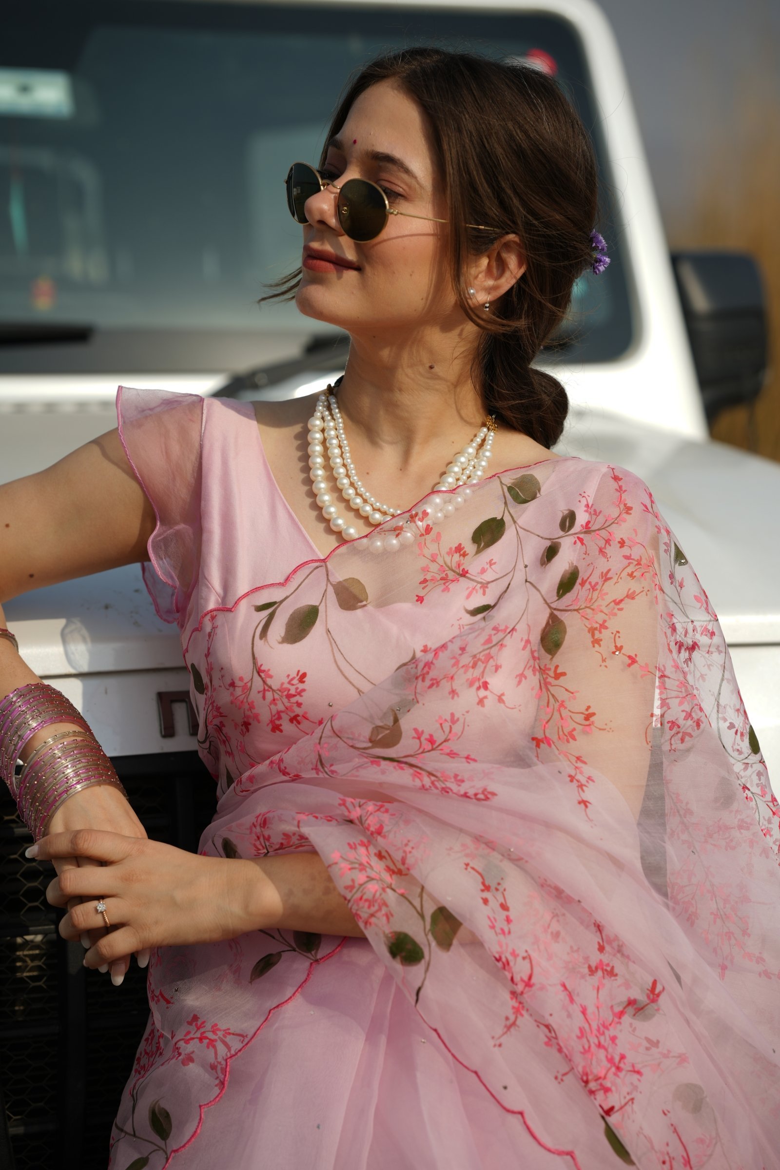 Detailed shot of the handpainted cherry blossom motifs and sheer pure organza silk fabric.