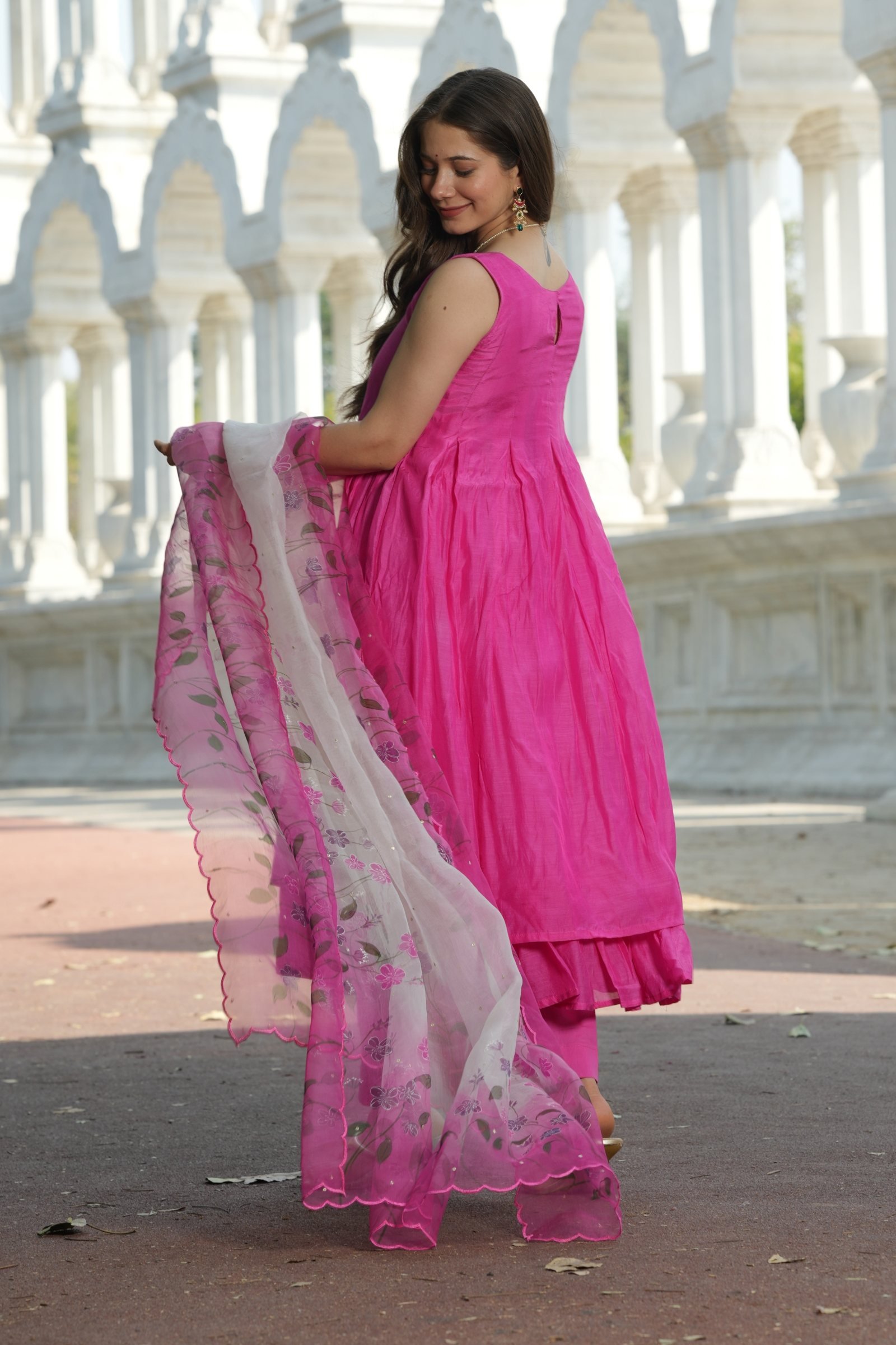 Back view of the vibrant Fuchsia Anarkali suit set, showing the gathered fabric and dupatta artistry.