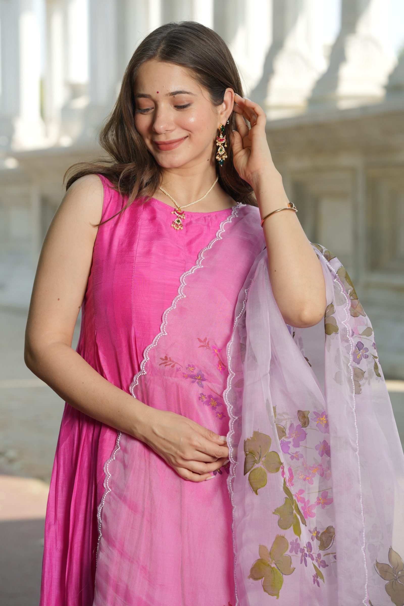 Detailed shot of the handpainted Plumeria flowers and sequence work on the pink-ombre pure organza silk dupatta.