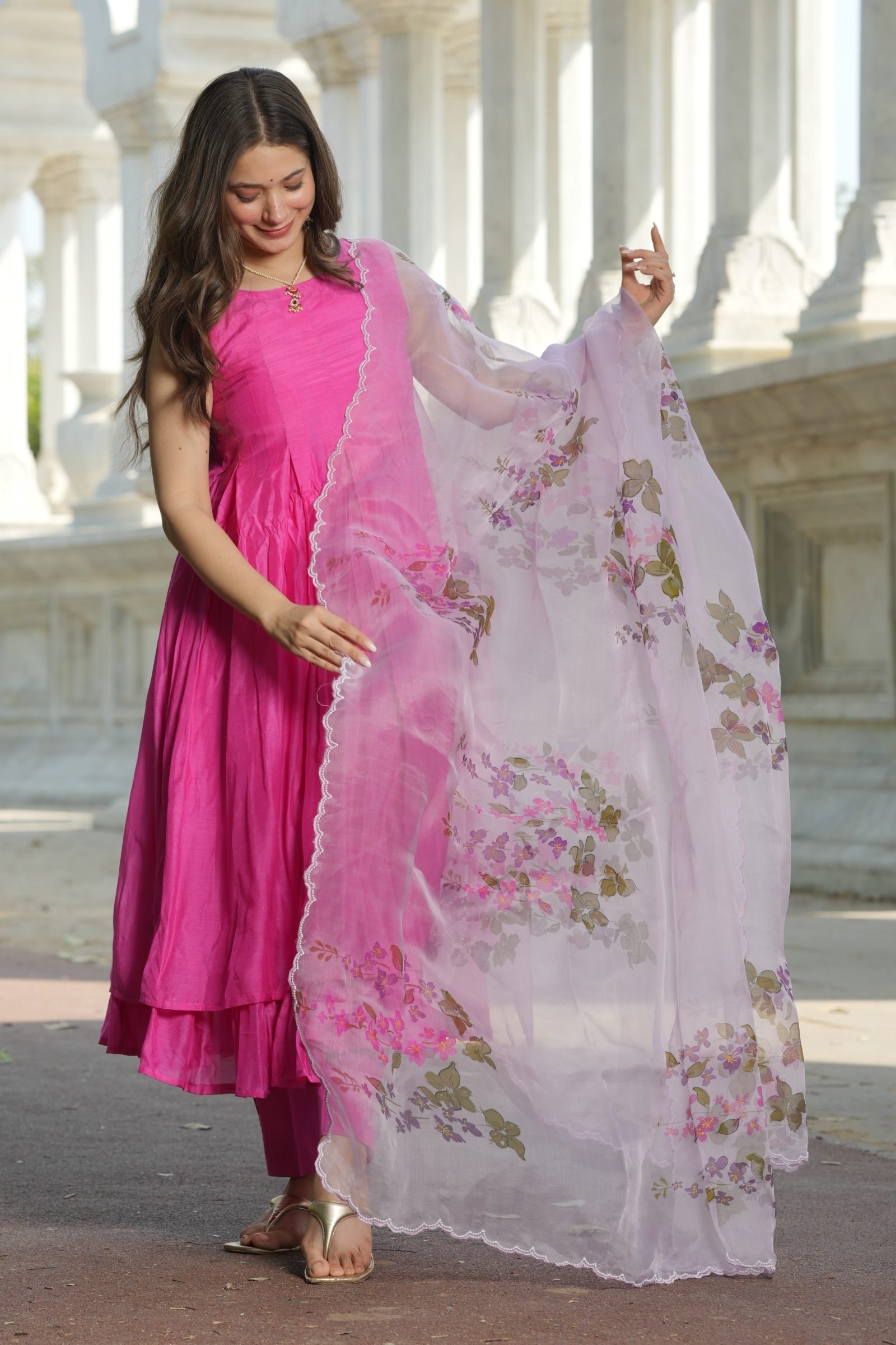 Side view of the Fuchsia Chanderi Anarkali, showing the flow and the handpainted Plumeria motif on the pure organza dupatta.