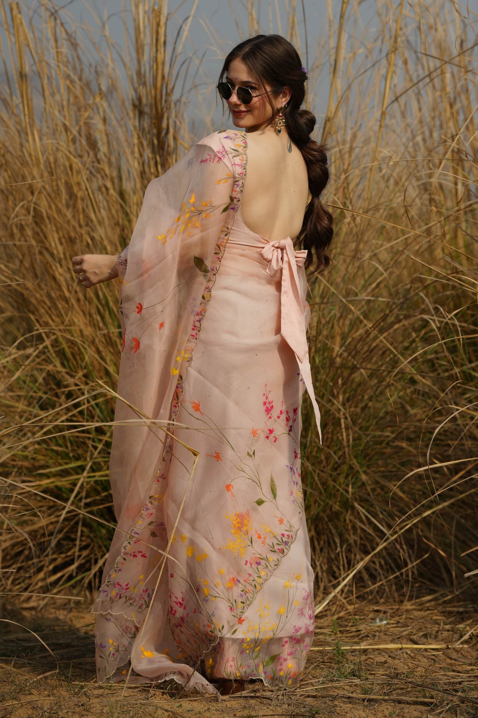 Back view of the Wildflower Meadow Organza Saree, highlighting the continuous wildflower painting along the border.