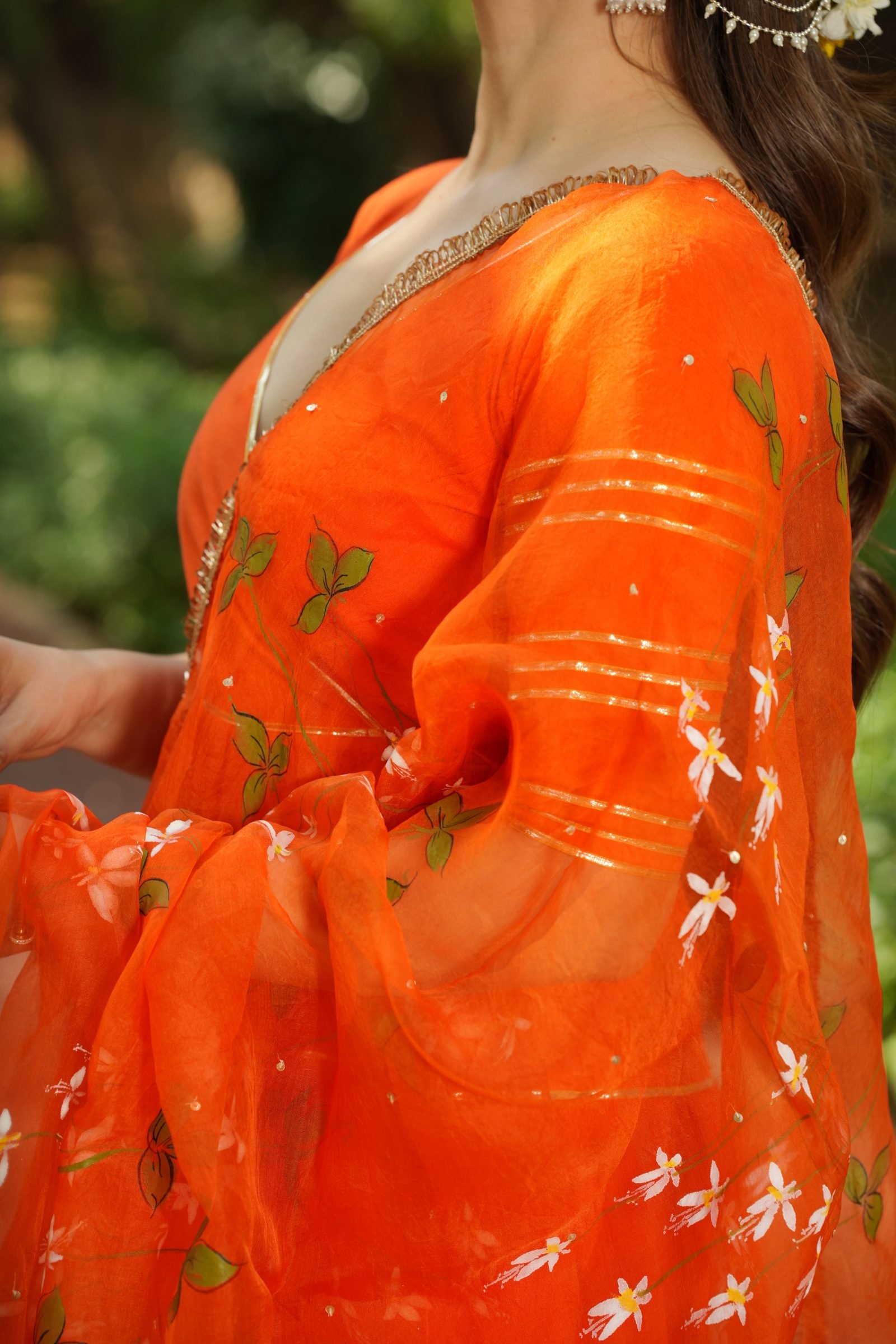 Fabric detail of the Marigold Melody Orange Anarkali and the Gota Patti trim.
